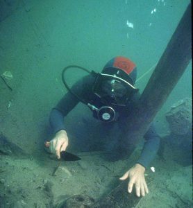 An archaeologist investigating the shipwreck The Betsy underwater.