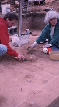 For delicate excavation an archaeologist will drop the shovel and pick up a trowel. An archaeologist uses a trowel in various ways. The point and edge of the trowel are used for careful excavation. But, the edge of the trowel is mainly used to scrape the surface of an excavated level or profile to bring out the color and texture of the soil. In a sense it is like shaving the surface of the soil. The archaeologist then interprets the clean soil surface, noting soil layers in a profile or discolorations, called features, in the floor of a square. Trowelling is done not only to interpret the soil, but to provide a clean surface for photographing the excavation to document for posterity. Click on the "Try It" icon and excavate a site.