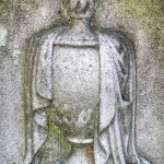 URN: Represents the deceased person’s remains. The urn is often draped (consistent with Victorian sensibilities) and may include an eternal flame.