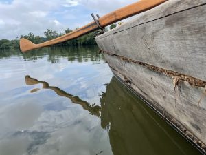 A beautiful new sweep oar, made by the crew, is in contrast to the weathered planks of the Mary Ingles. Note the caulking between the planks.