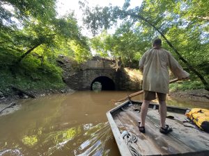 Kevin steers the Mary Ingles up Bremo Creek into a stone culvert that once carried the James River & Kanawha Canal over the creek but now carries train traffic.