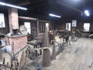 Interior of Outlaw Blacksmith Shop Showing Examples of his Work and the Rebuilt Forge