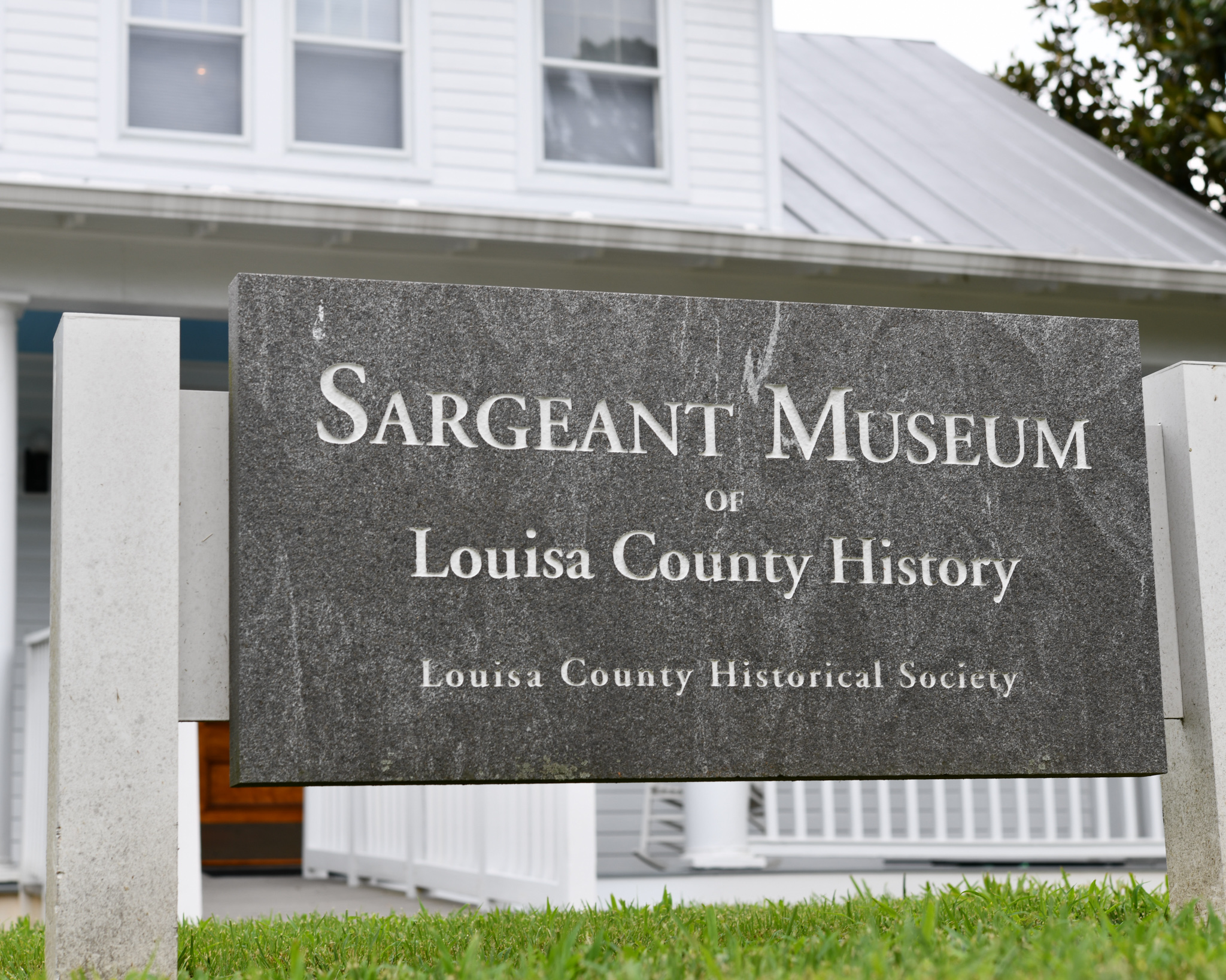 Granite sign in front of a historic building reading Seargeant Museum of Louisa County History, Louisa County Historical Society
