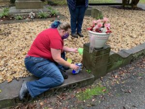 Kate Ridgway removes graffiti from Maggie Walker grave stone